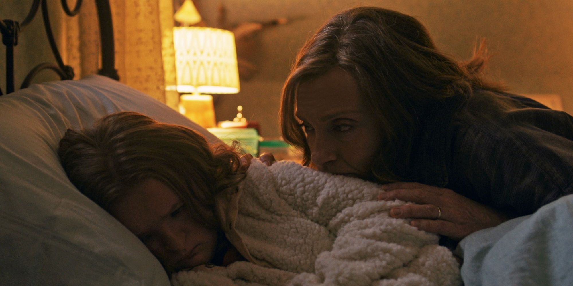 A still from 'Hereditary', showing a mother leaning over her daughter