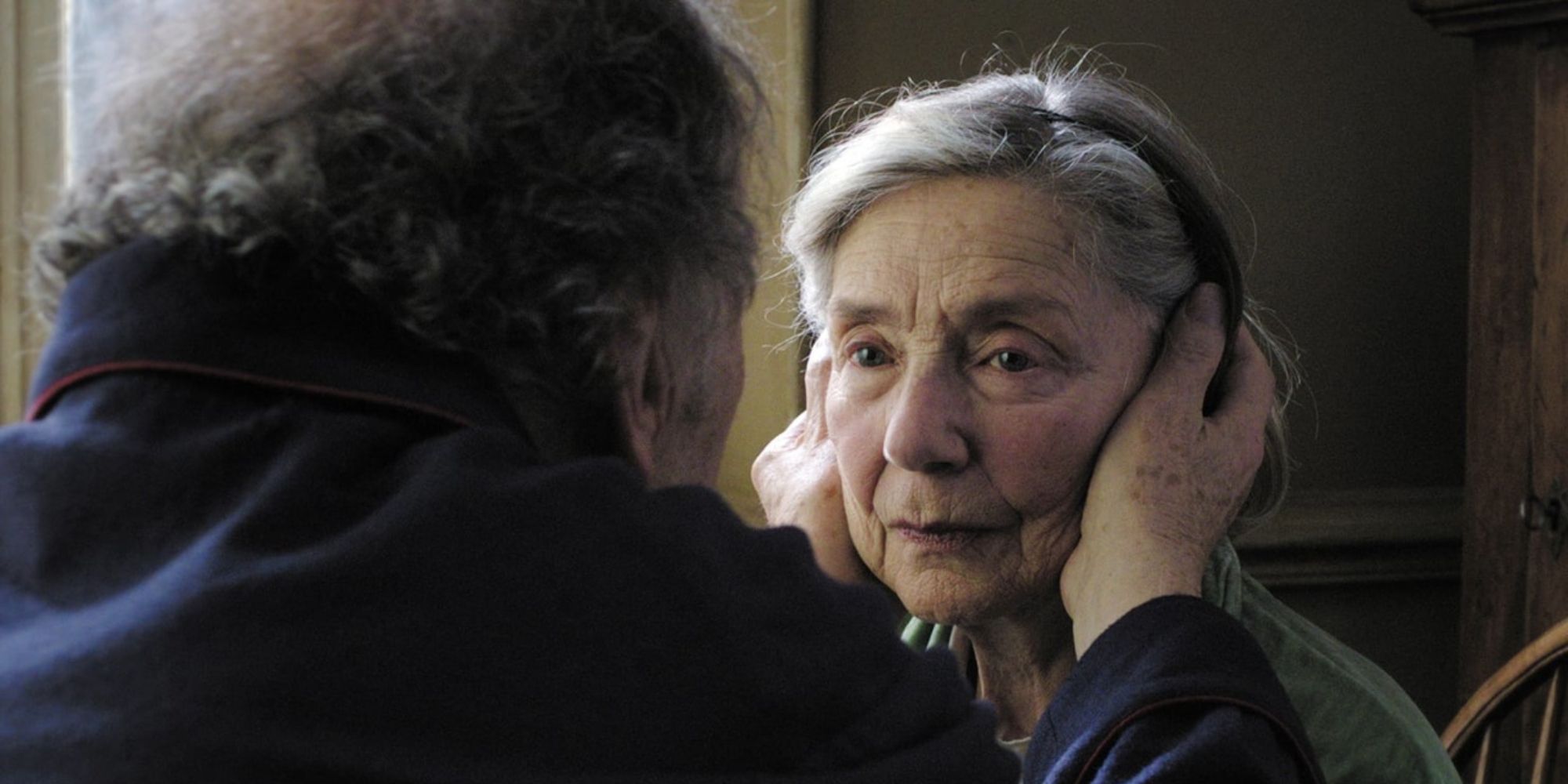 Jean-Louis Trintignant tenant le visage d'Emmanuelle Riva dans 'Amour'.