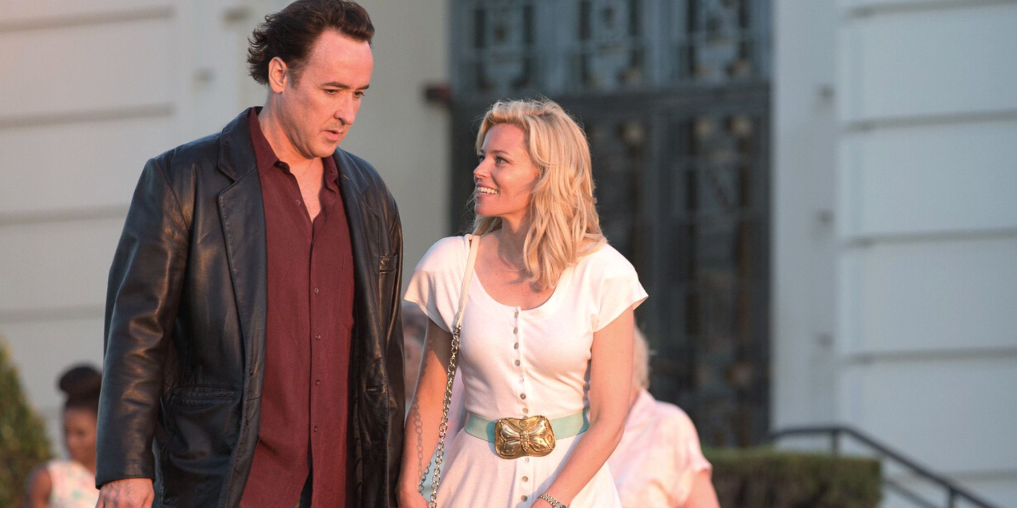 John Cusack standing to Elizabeth Banks who is looking at him in Love & Mercy
