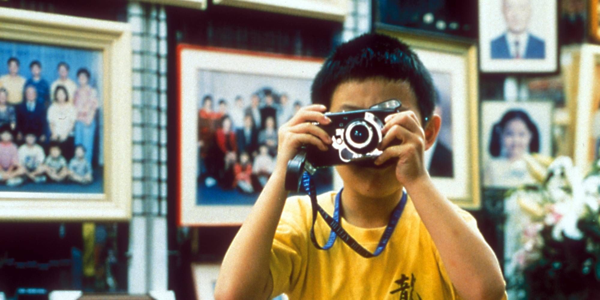 Jonathan Chang taking a picture with a camera in 'Yi Yi'