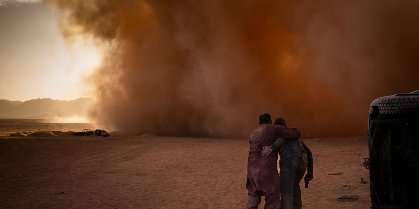 Gerard Butler and Navid Negahban walking into a dust storm in Kandahar