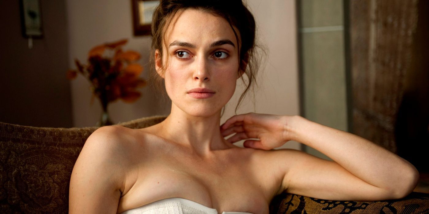 Sabina Spielrein sitting on a couch and looking intently at someone off-camera in A Dangerous Method