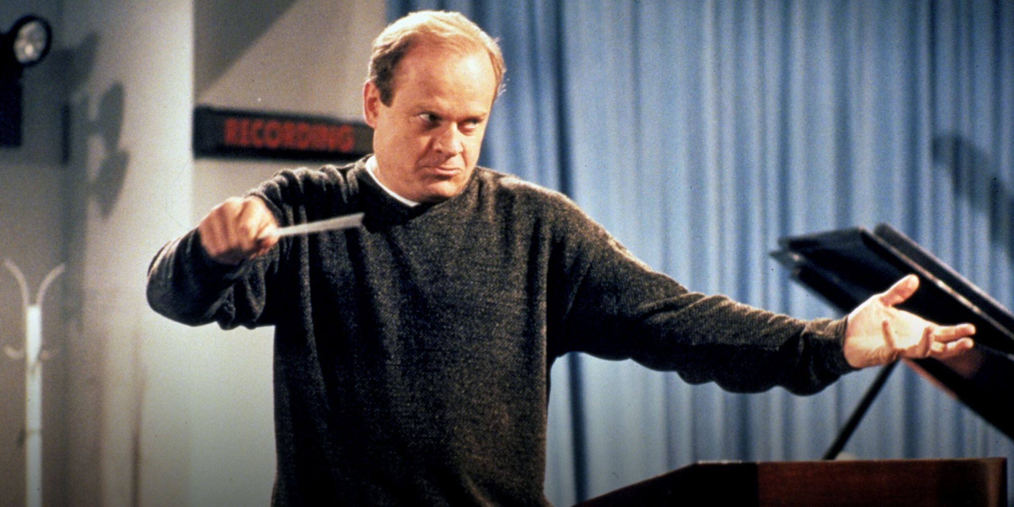 Kelsey Grammer conducting an orchestra in Frasier
