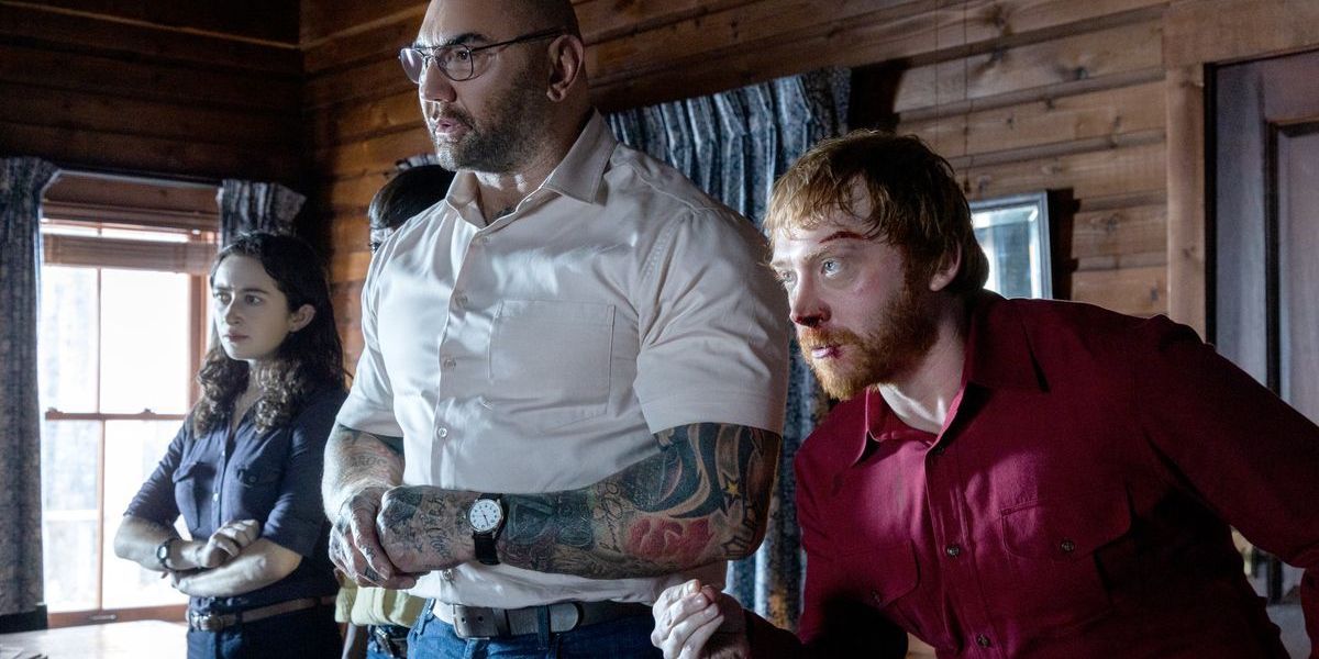 A screenshot of Knock at the Cabin featuring Dave Bautista and Rupert Grint