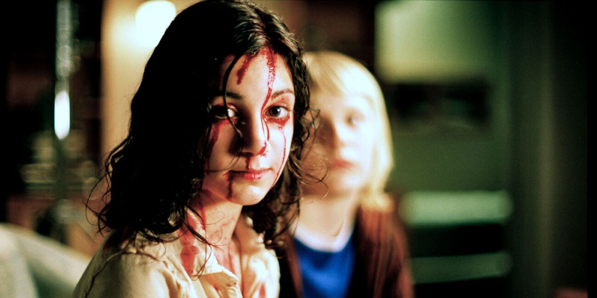 Lina Leandersson as Eli, a girl covered in blood in 'Let the Right One In'
