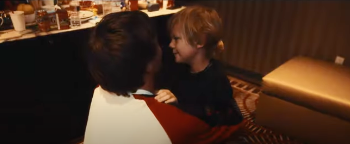 Louis Tomlinson hugging his son