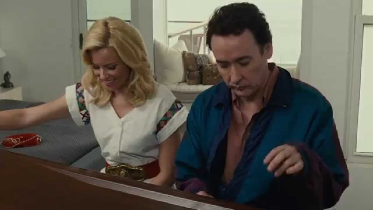 Elizabeth Banks and John Cusack sitting at a piano in Love & Mercy. 