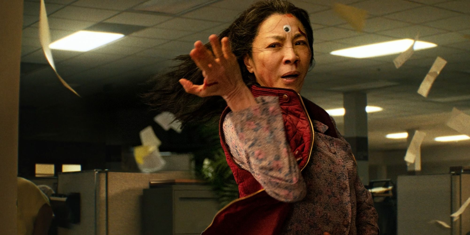 Michelle Yeoh doing martial-arts with a googly eye on her head in 'Everything Everywhere All at Once'