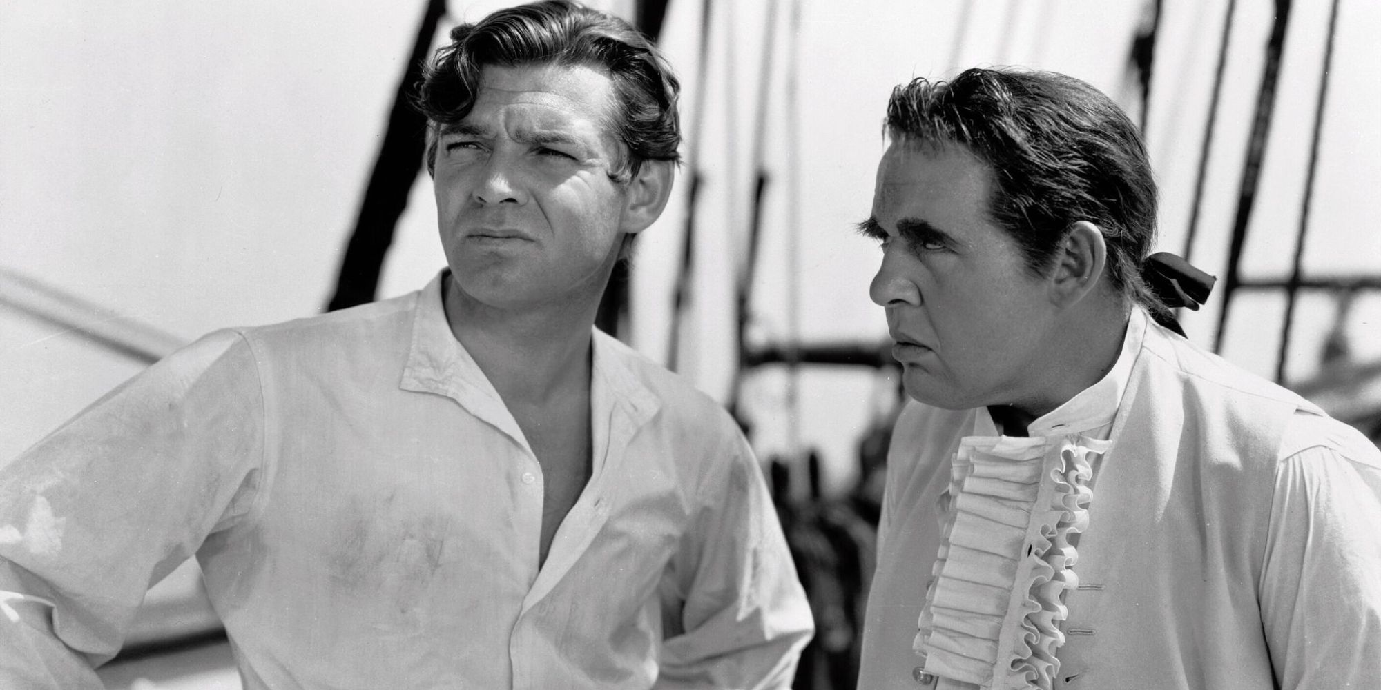 Fletcher Christian and Captain Bligh, standing on a ship and looking out to sea in Mutiny on the Bounty