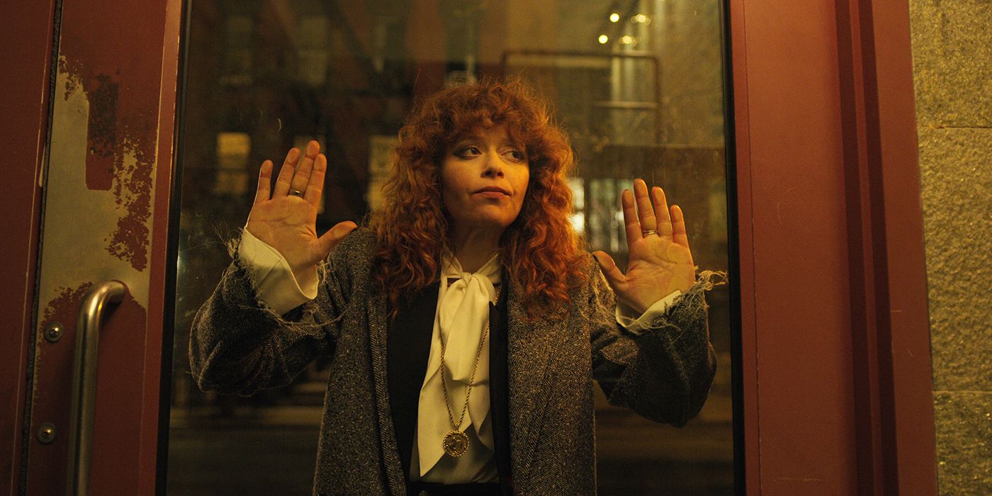 Natasha Lyonne with her hands up against the glass doors of a subway in Russian Doll