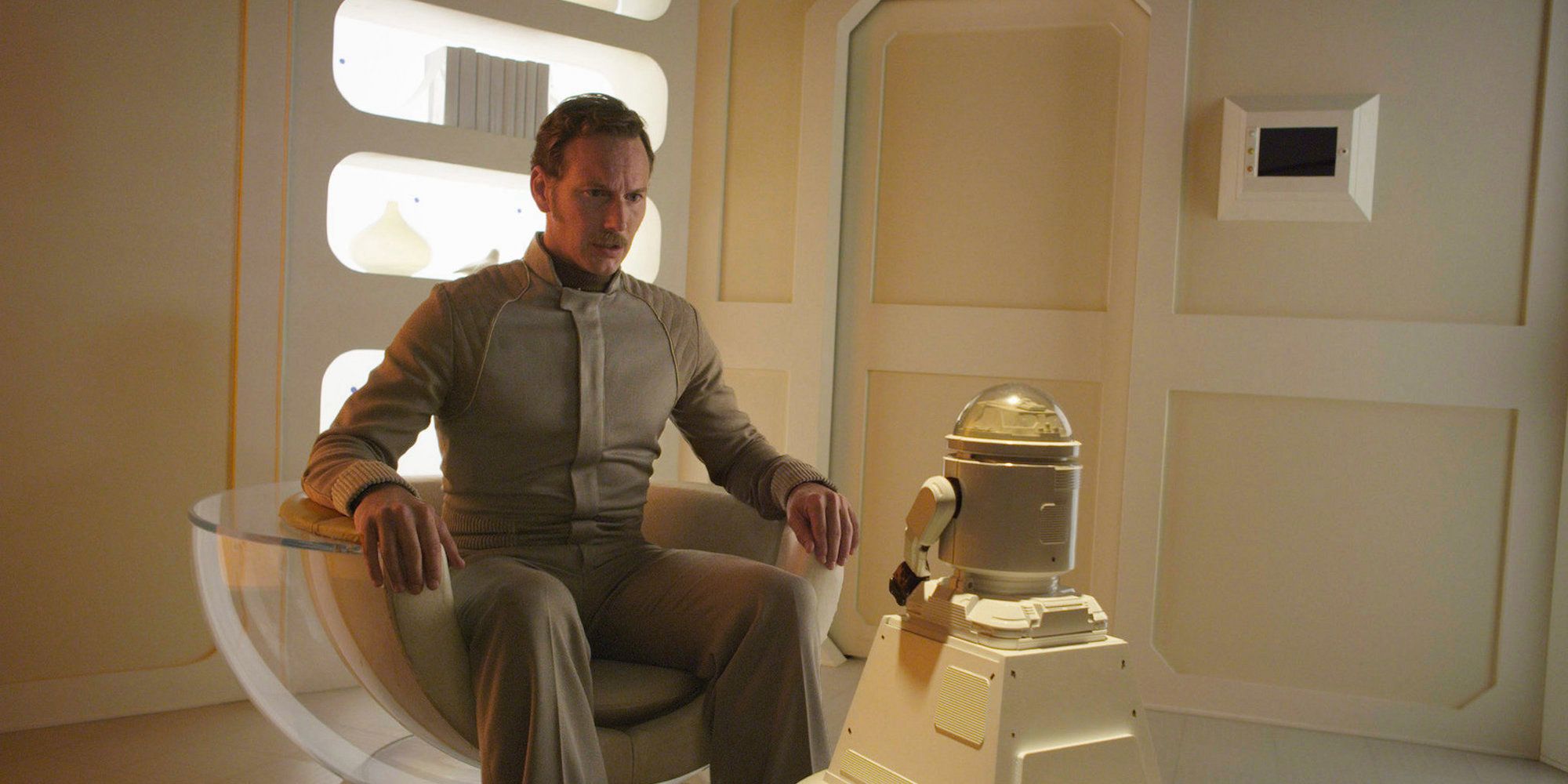 Patrick Wilson talks to a small robot in Space Station 76-1