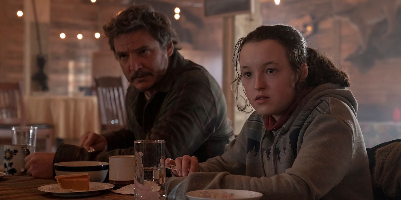 Pedro Pascal as Joel and Bella Ramsey as Ellie sit at a counter in a diner in The Last of Us Episode 6.