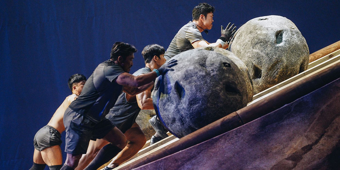 Contestants on Physical: 100 push boulders uphill as part of a fourth-week challenge. 