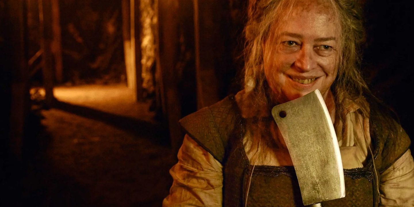 The Butcher, played by Kathy Bates, grinning and holding a cleaver in 'AHS: Roanoke'