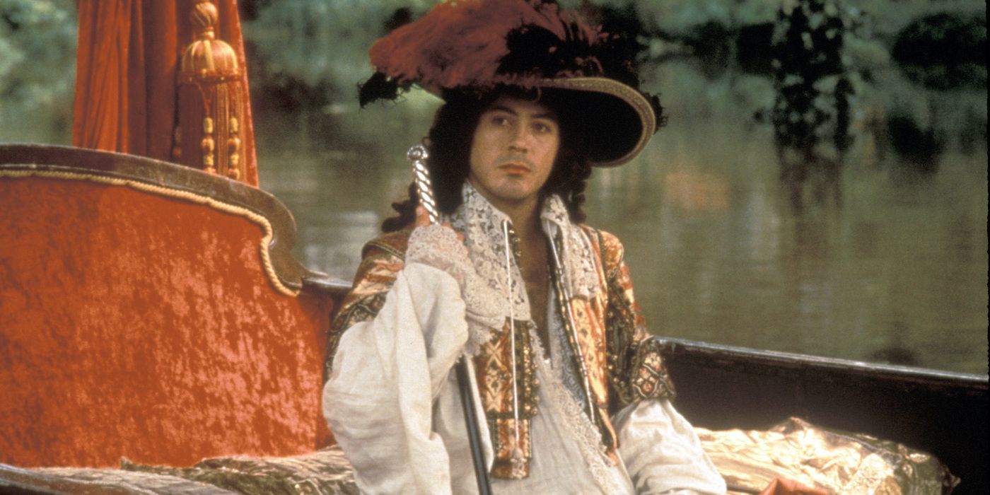 Robert Downey Jr. in period clothing and a large hat sits in a small boat in Restoration.