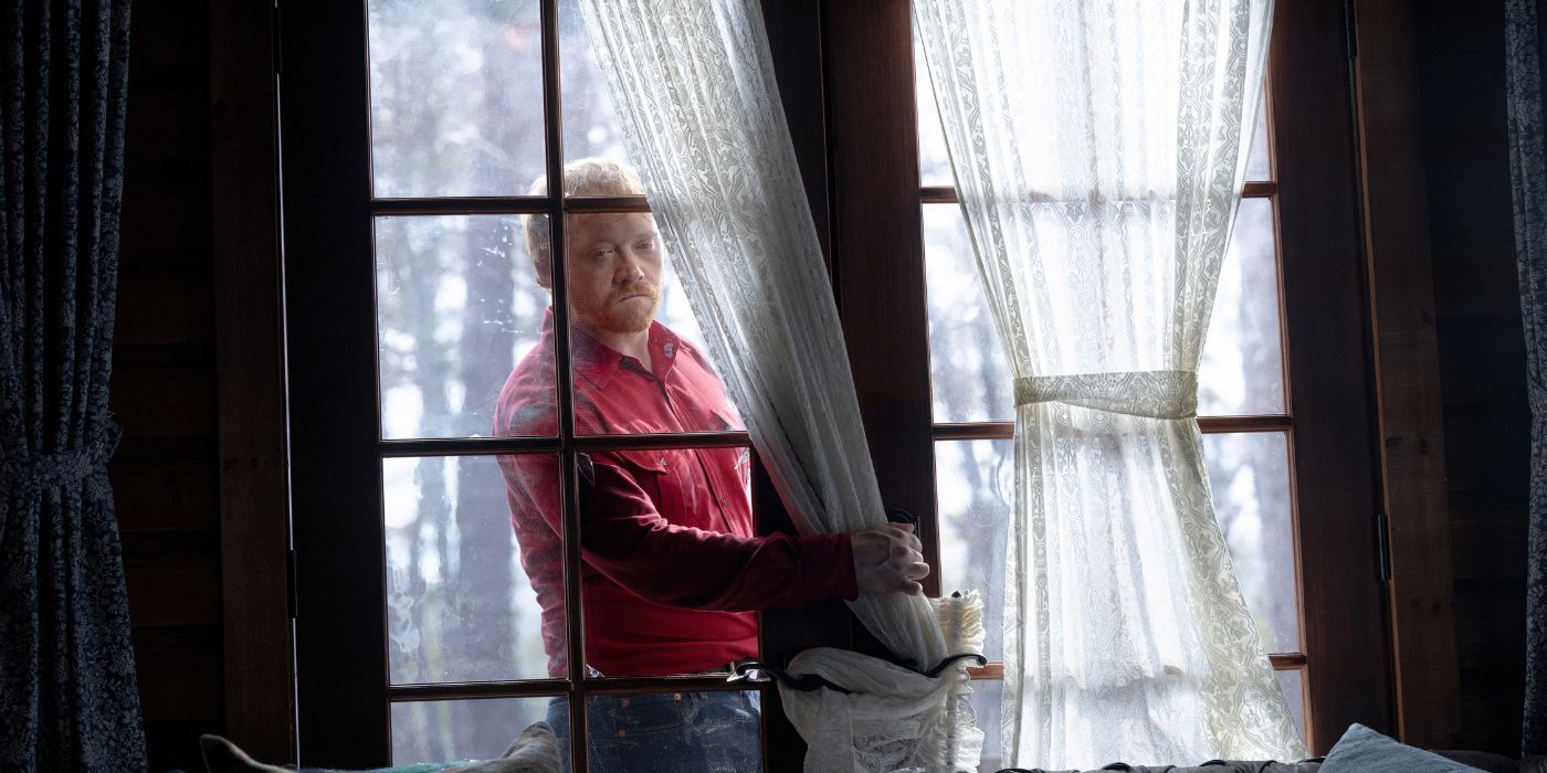 Rupert Grint as Redmond outisde of a house in Knock at the Cabin