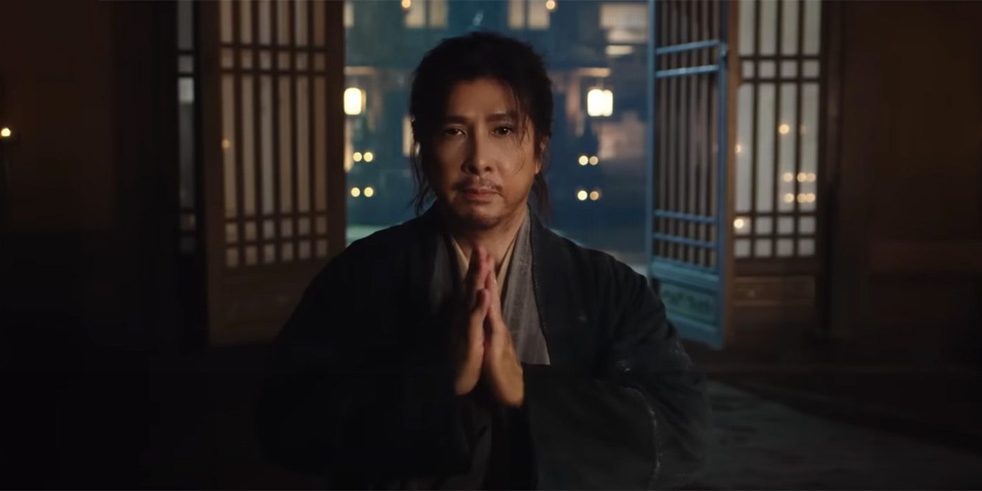 Donnie Yen with his hands pressed together as if in prayer in Sakra