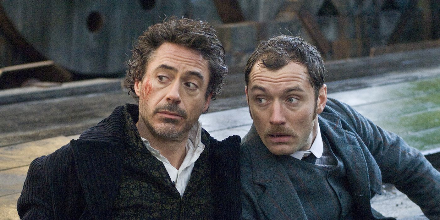 Sherlock Holmes (Robert Downey Jr.) and John Watson (Jude Law) looking offscreen in 'Sherlock Holmes'