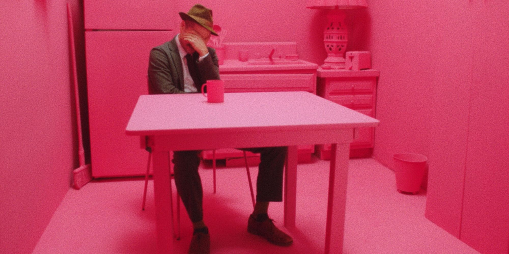 Kentucker Audley sits alone in an all pink room in his film Strawberry Mansion 