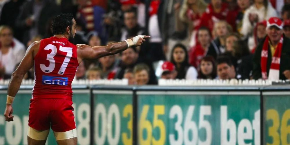 Sydney Swans footballer Adam Goodes points to someone in the crowd.