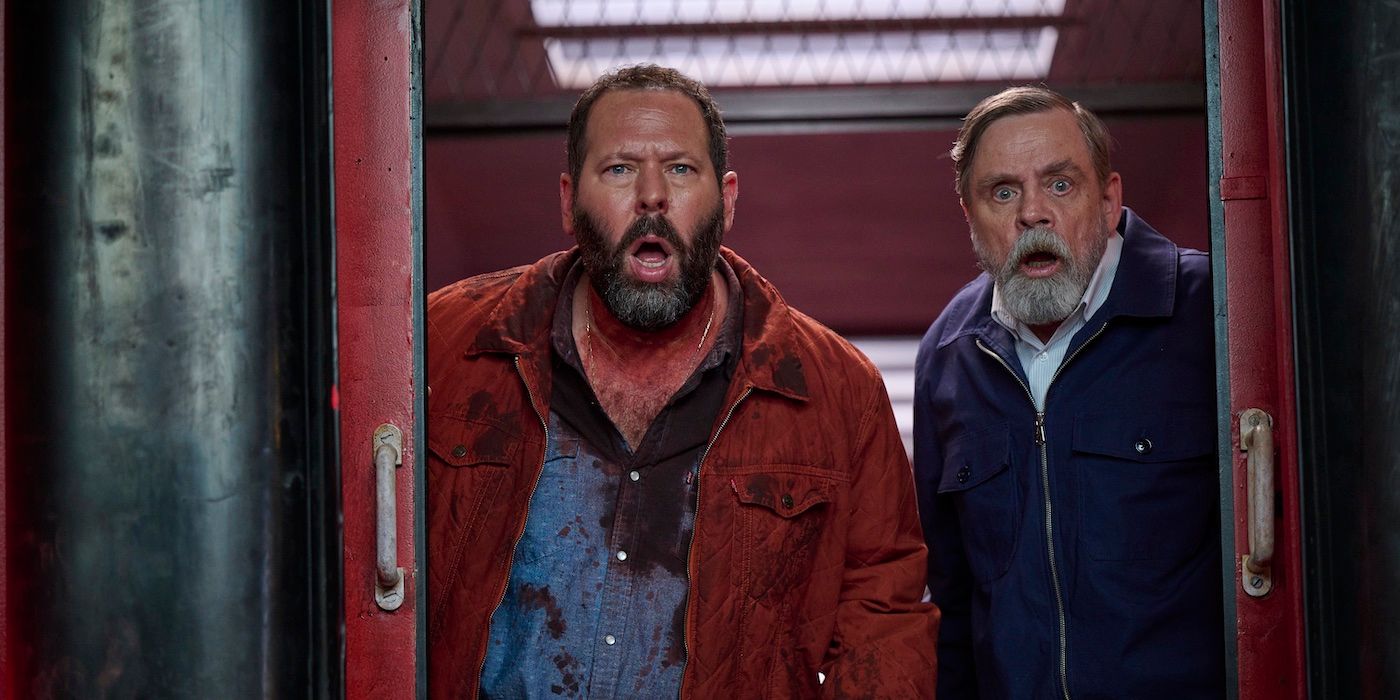 Bert Kreischer and Mark Hamill look at something in shock in The Machine.