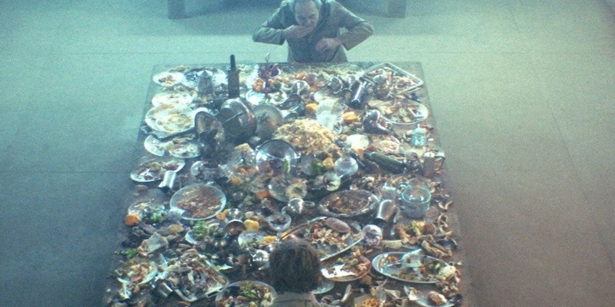 A still from 'The Platform', showcasing a large table covered in food