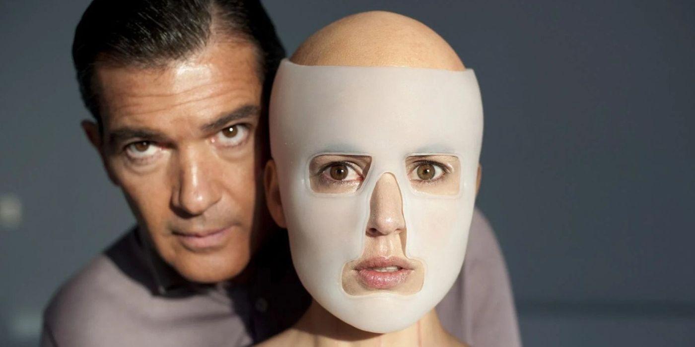Vera, played by Elena Cruz, with a translucent plastic mask on her face while Ledgard, played by Antonio Banderas, stands behind her in 'The Skin I Live In'