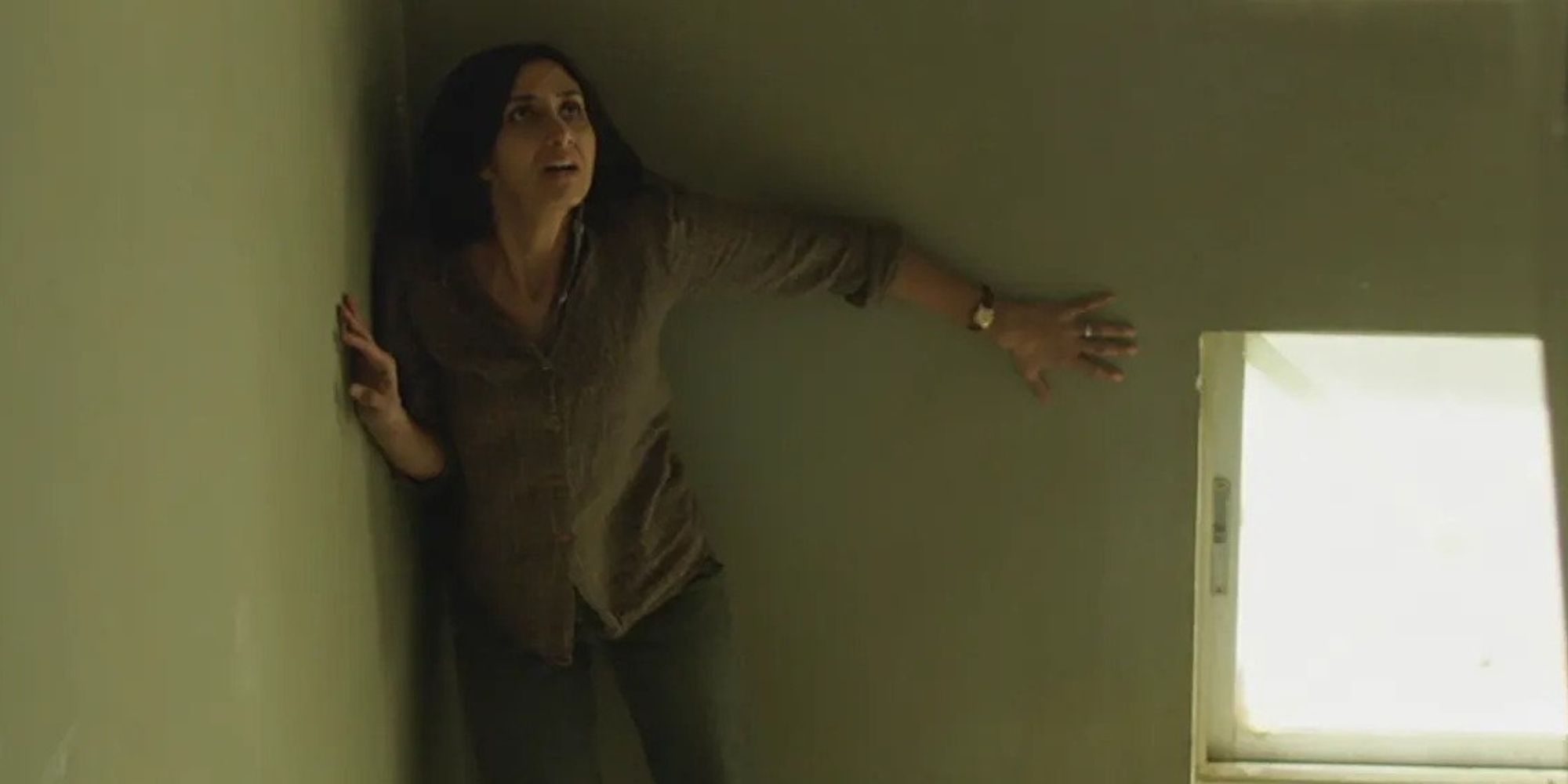 A frightened woman against a wall in 'Under The Shadow'