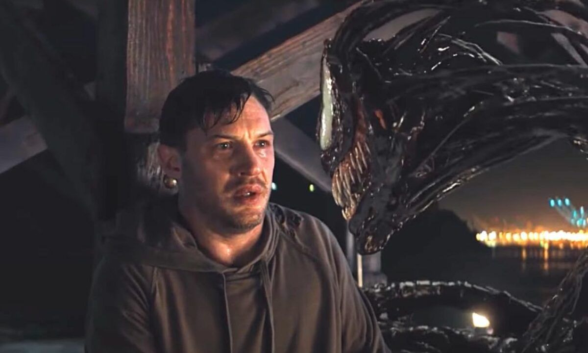 Venom and Eddie staring at each other 