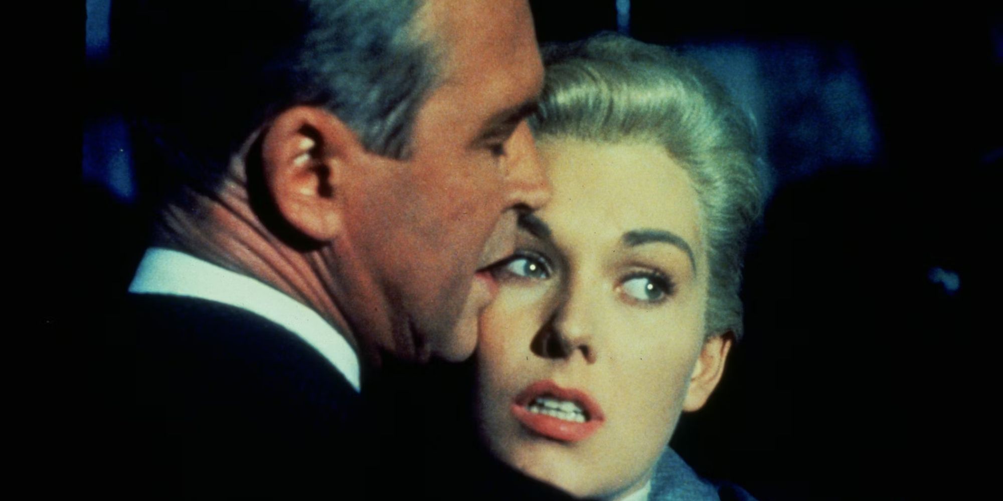 Kim Novak and James Stewart as Madeline and John touching faces in Vertigo.