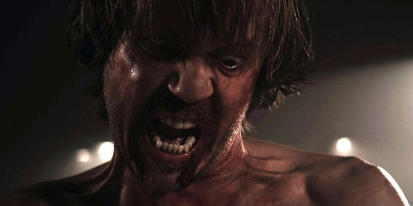 A bloody man yelling in rage in A Serbian Film