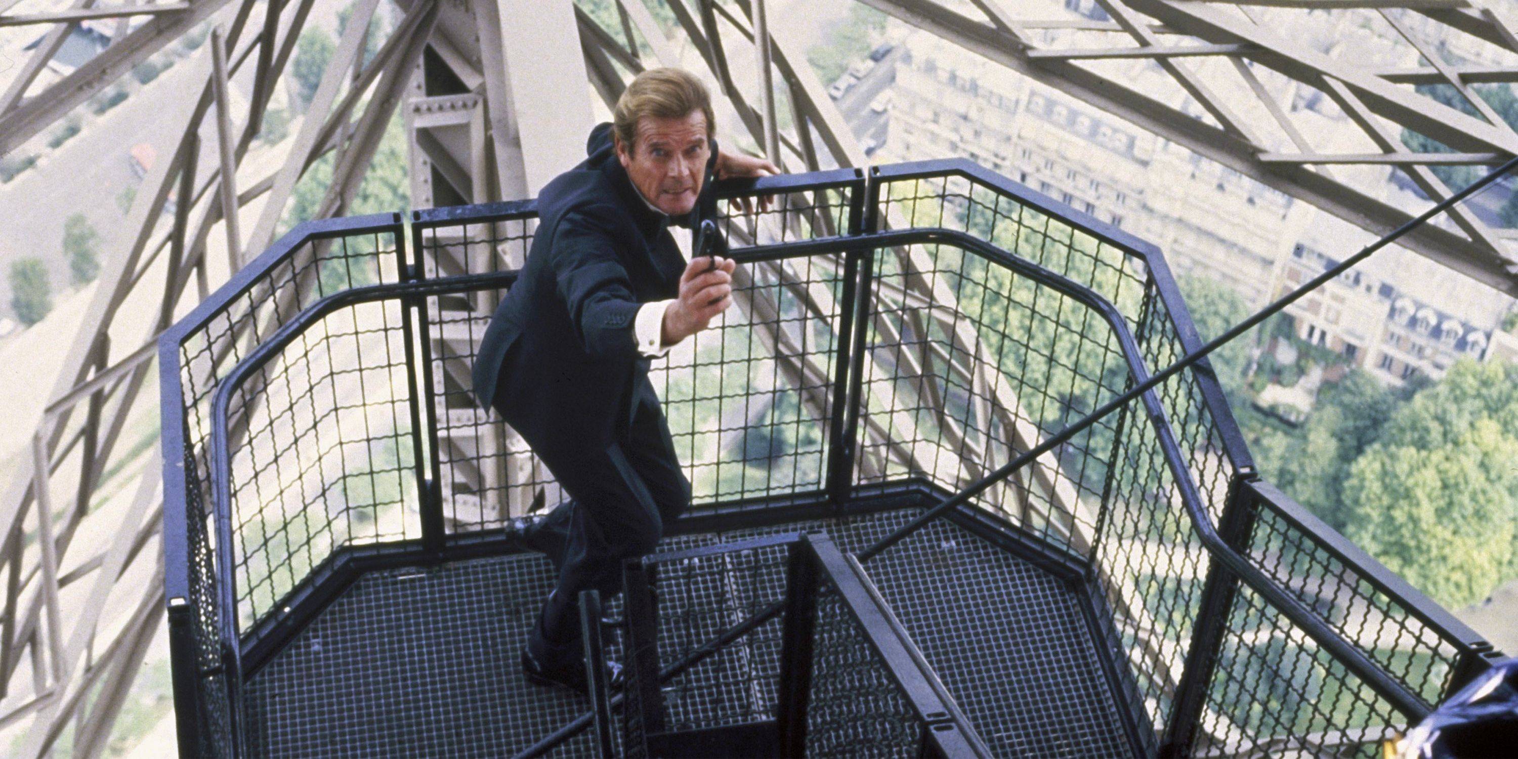 James Bond (Roger Moore) aims his weapon as he climbs a perilously high flight of stairs in A View to Kill