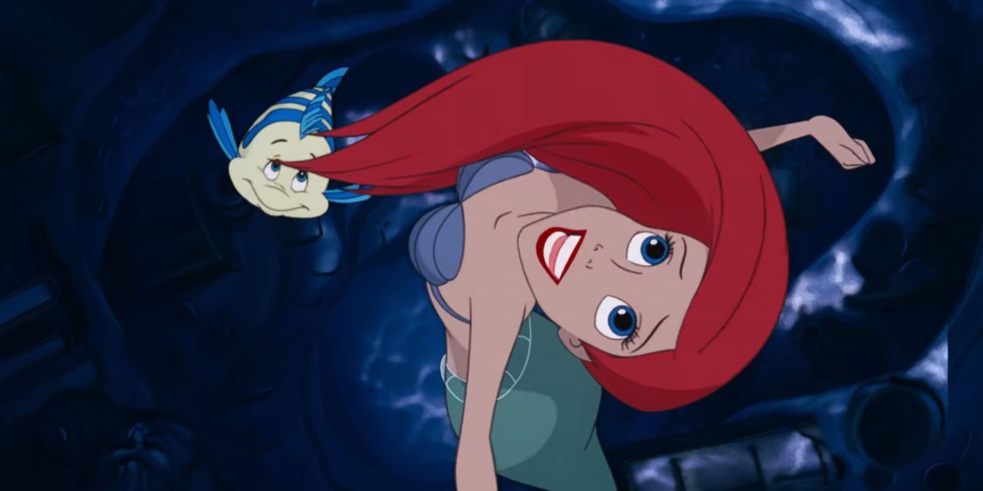 Ariel et Flounder sourient et nagent en regardant vers le ciel dans La Petite Sirène (1989).