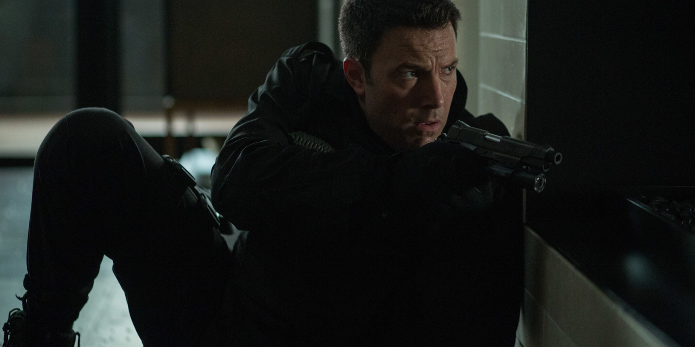 Ben Affleck as Christian Wolff taking cover while turning back in the Accountant
