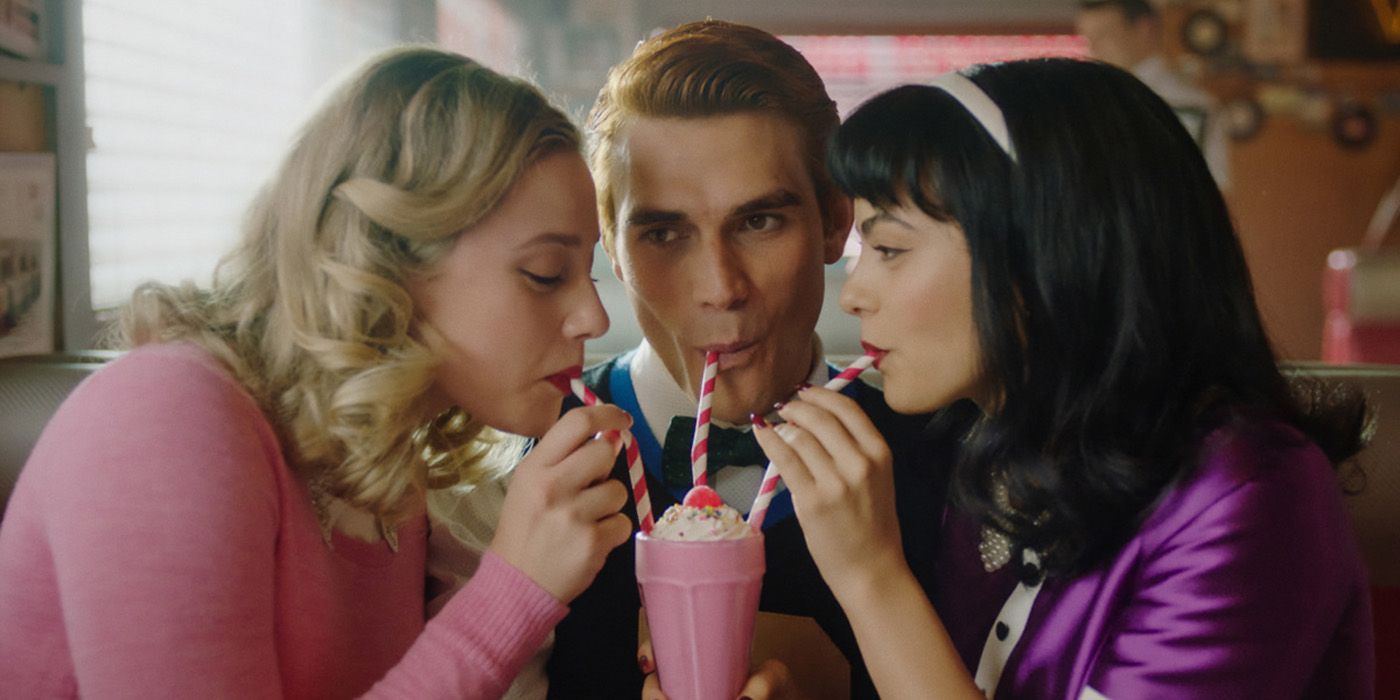 Lili Reinhart KJ Apa and Camila Mendes sharing a milkshake in Riverdale