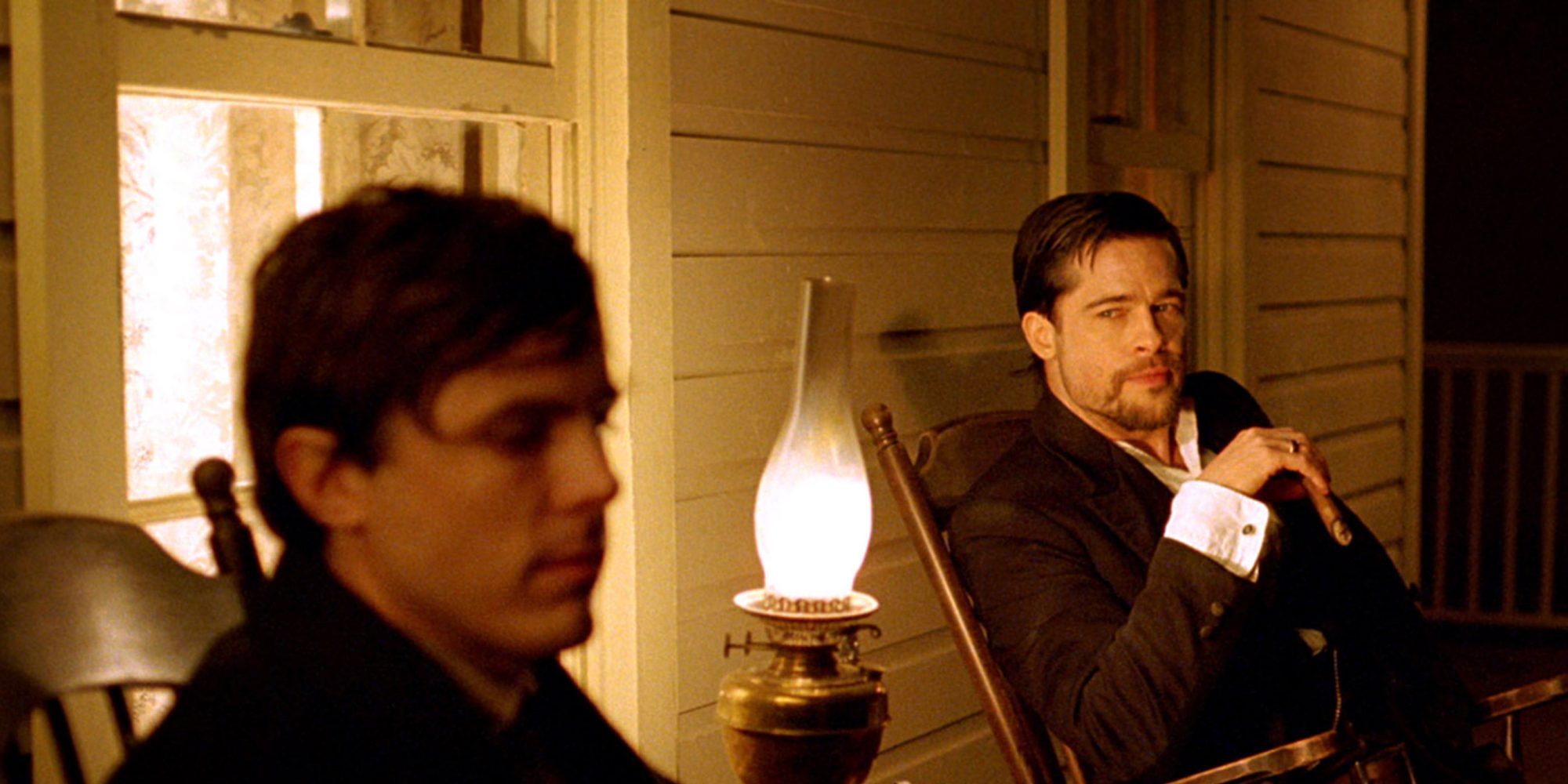 Casey Affleck and Brad Pitt sitting together in The Assassination of Jesse James by the Coward Robert Ford