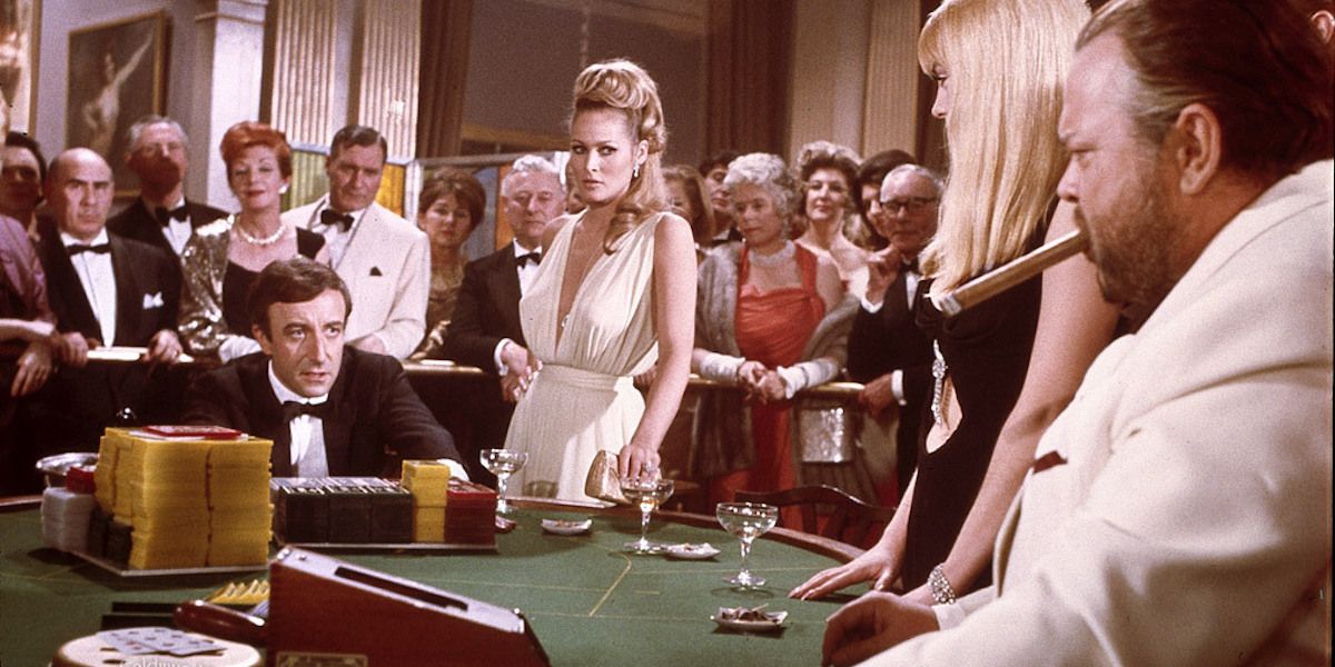 Peter Sellers as James Bond and Ursula Andress as Vesper Lynd at a casino table in Casino Royale (1967)
