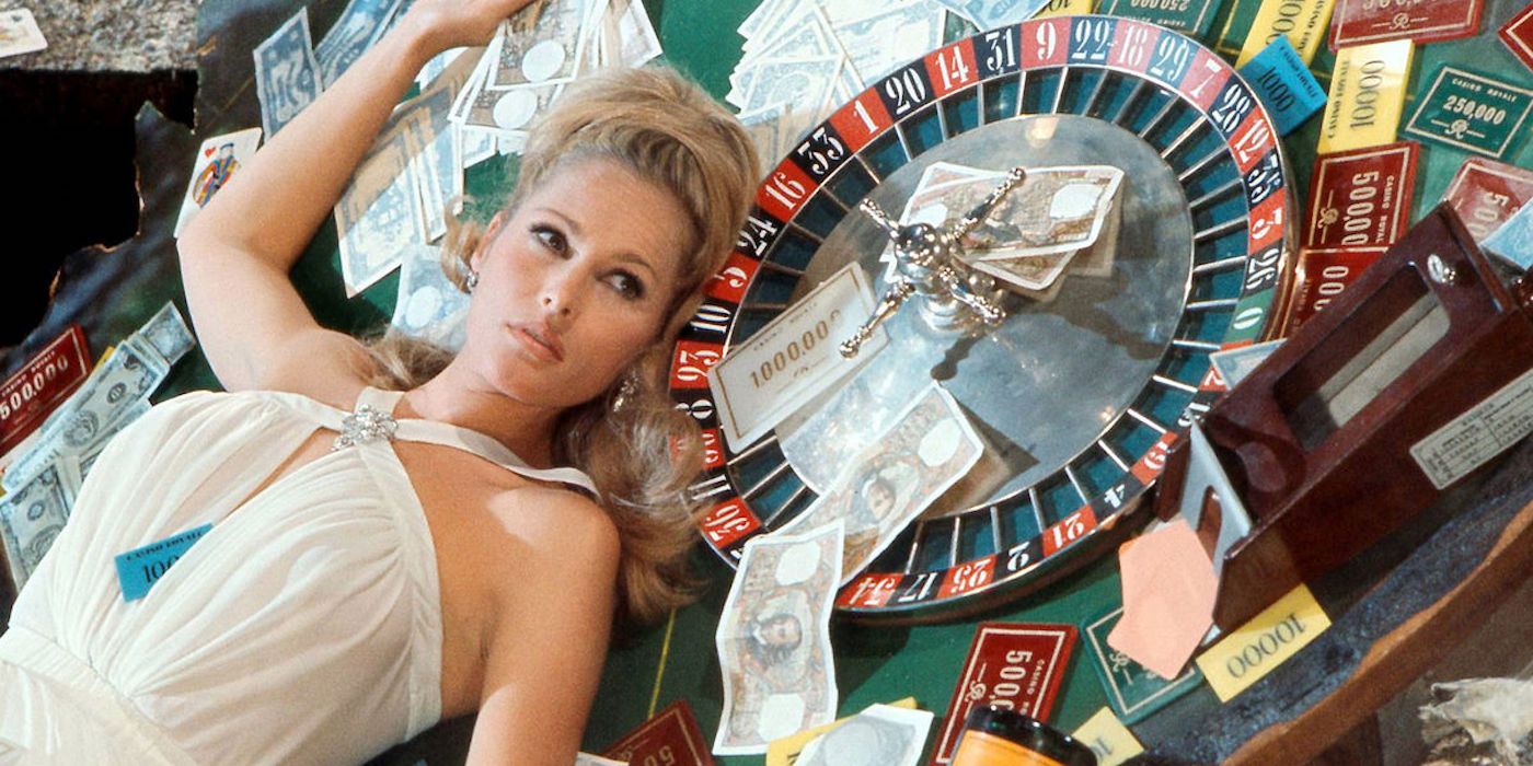 Ursula Andress as Vesper Lynd lying on a card table in Casino Royale (1967)