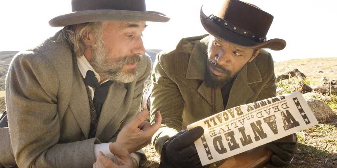 Dr. King Schultz (Christoph Waltz) and Django (Jamie Foxx) lay in the ground looking over a bounty.