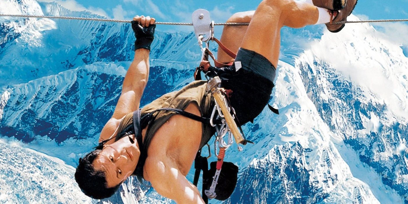 Gabe Walker (Sylvester Stallone) hangs on a cable line in the mountains in 1993's Cliffhanger