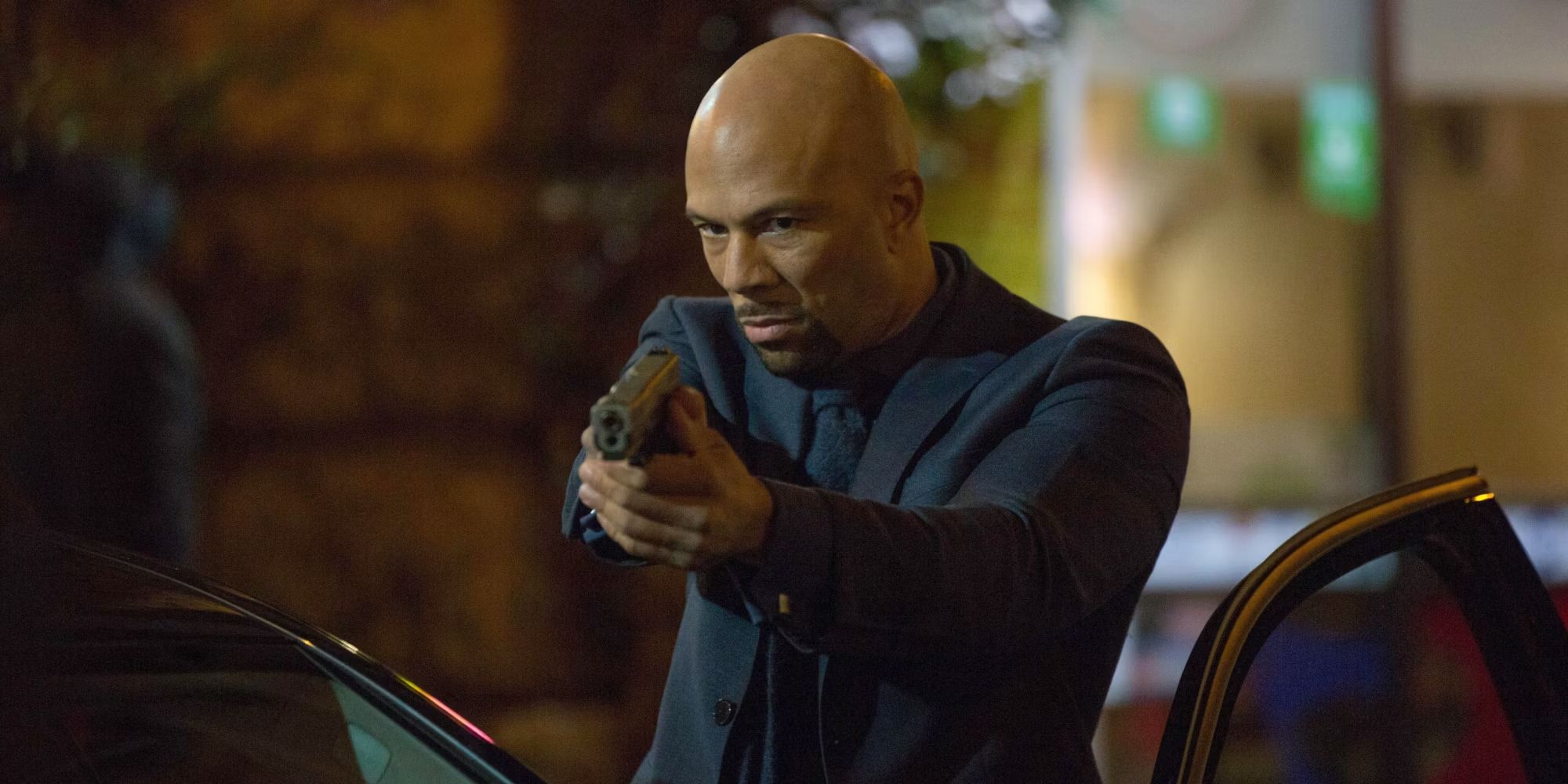 Common as Cassian holding a gun in John Wick Chapter 2