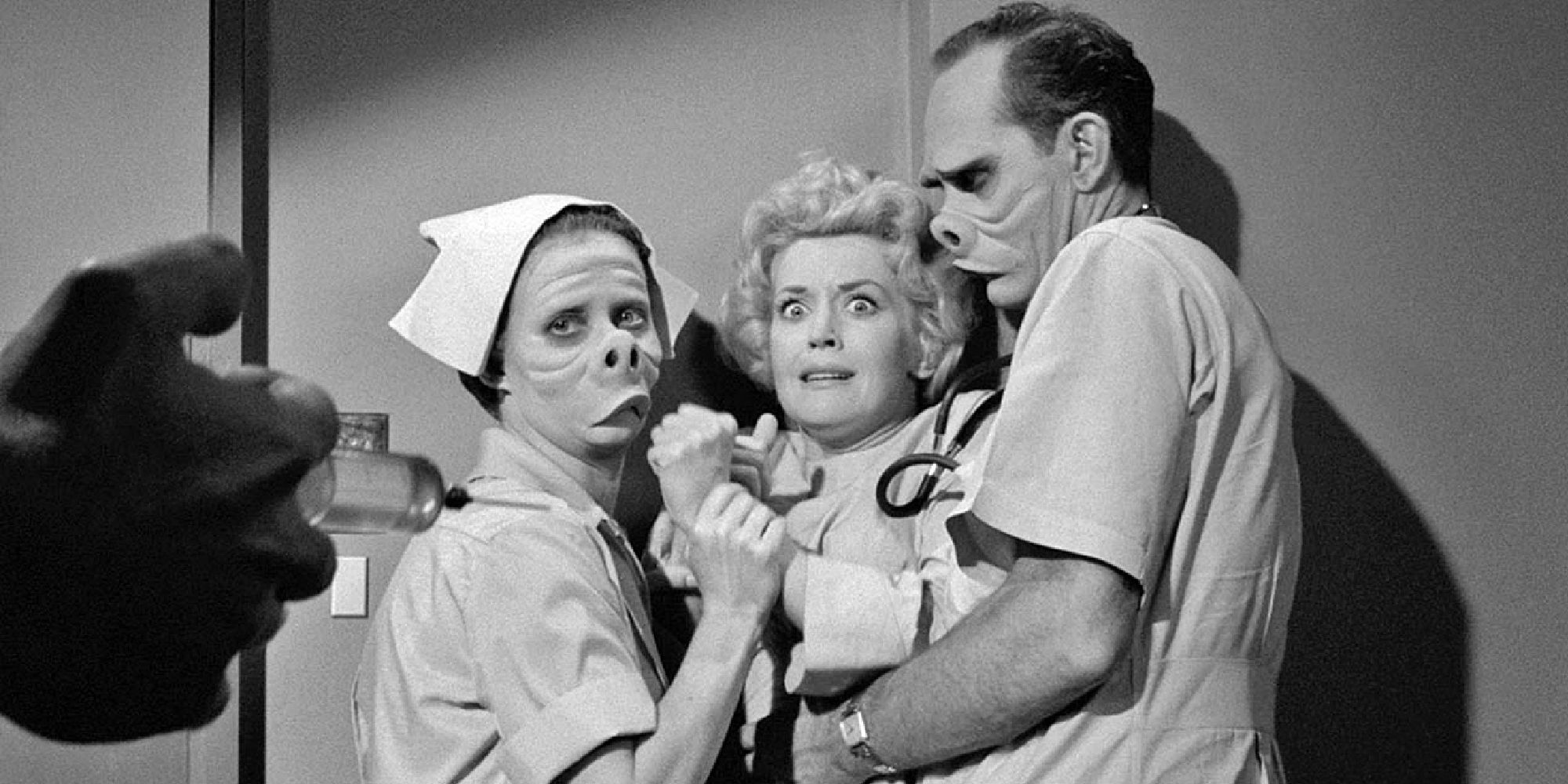 Two doctors with disfigured faces holding down a patient while someone approaches her with a syringe in The Twilight Zone