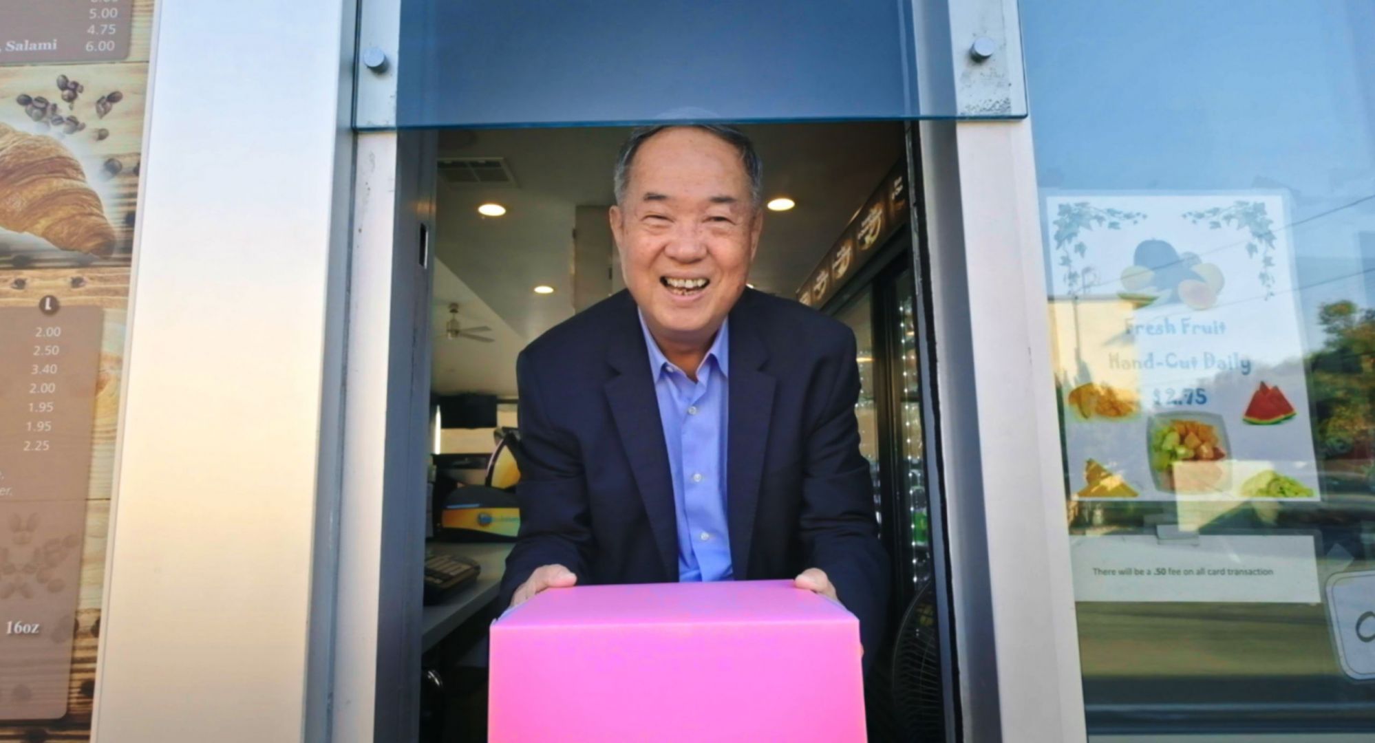 Ted Ngoy holding box of donuts in donut king