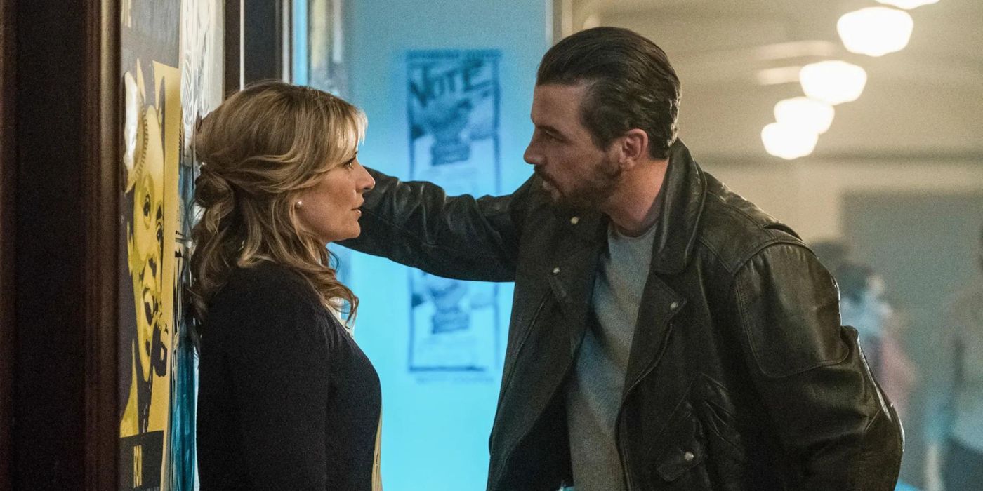 Madchen Amick's Alice Cooper stands with her back against a wall as she looks at Skeet Ulrich's FP Jones, who has his hand on the wall next to her head in Riverdale.