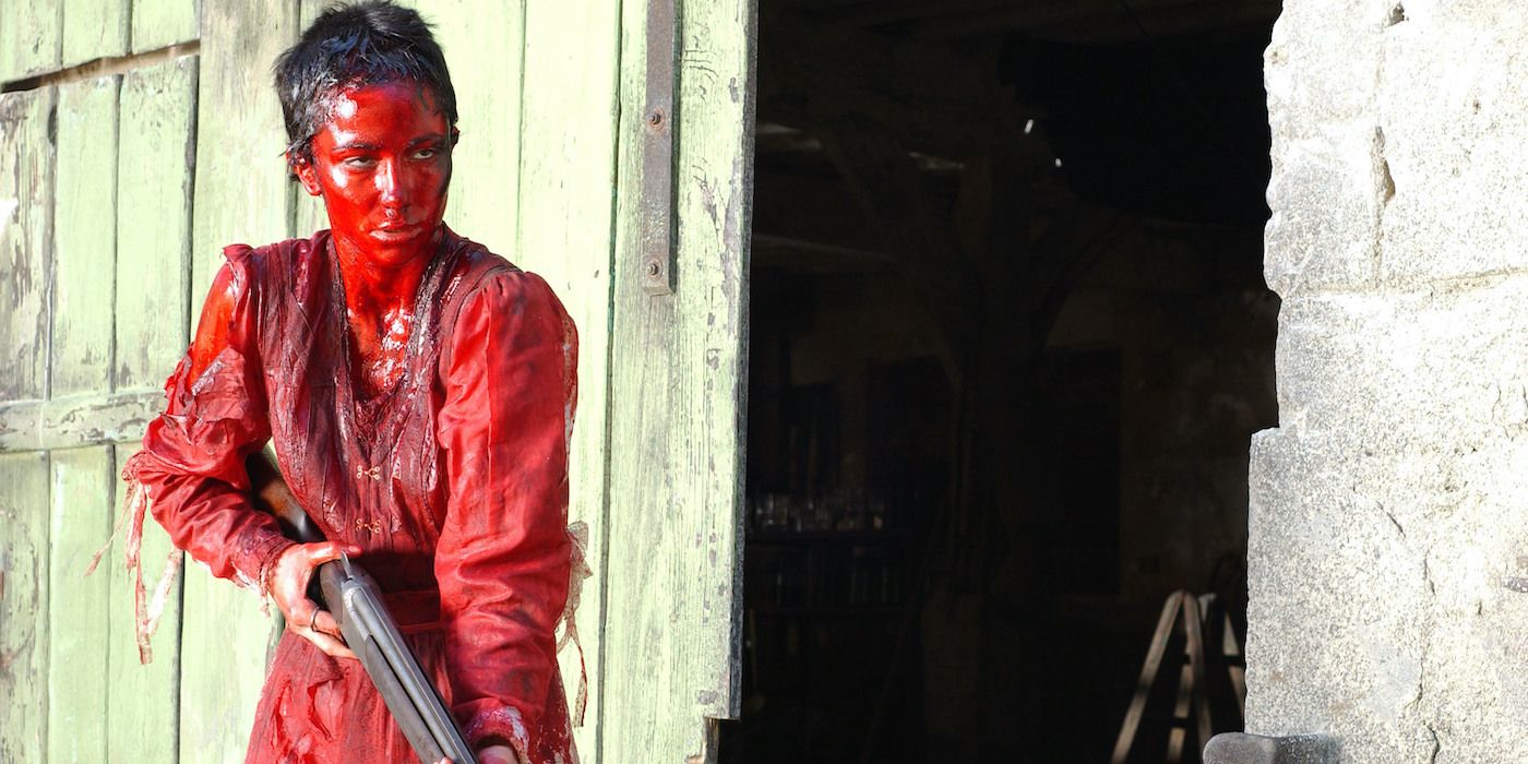 Karina Testa holding a gun while covered in blood in Frontier(s)