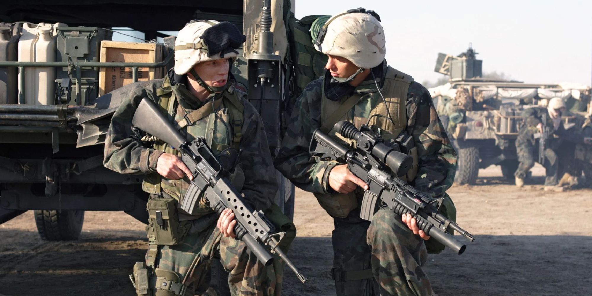 Two soldiers walking while holding guns in Generation Kill - 2008