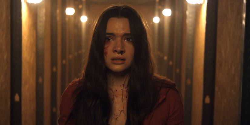 Harper walking down a hallway looking scared in Haunt (2019)