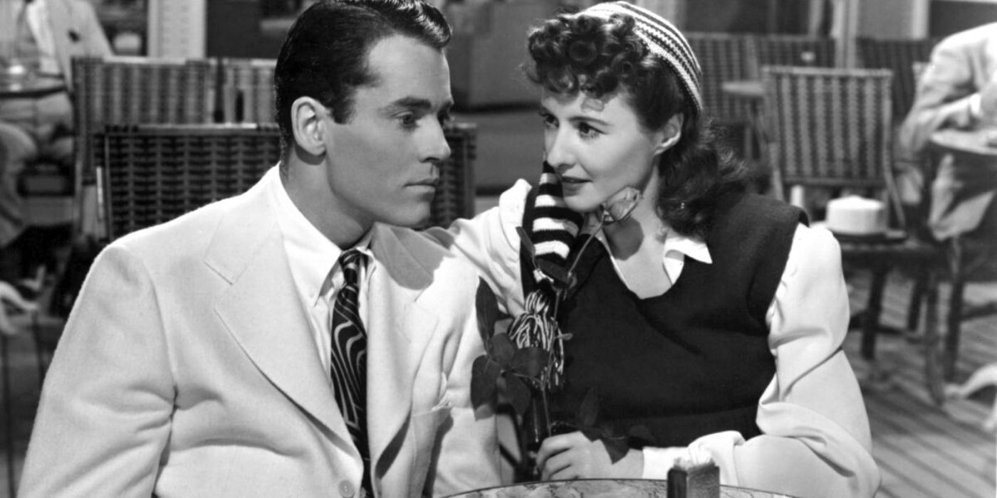 Henry Fonda sitting at a table with Barbara Stanwyck in The Lady Eve