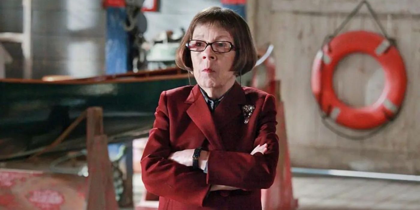 Linda Hunt's Hetty Lange wearing a red suit jacket and crossing her arms in NCIS: Los Angeles