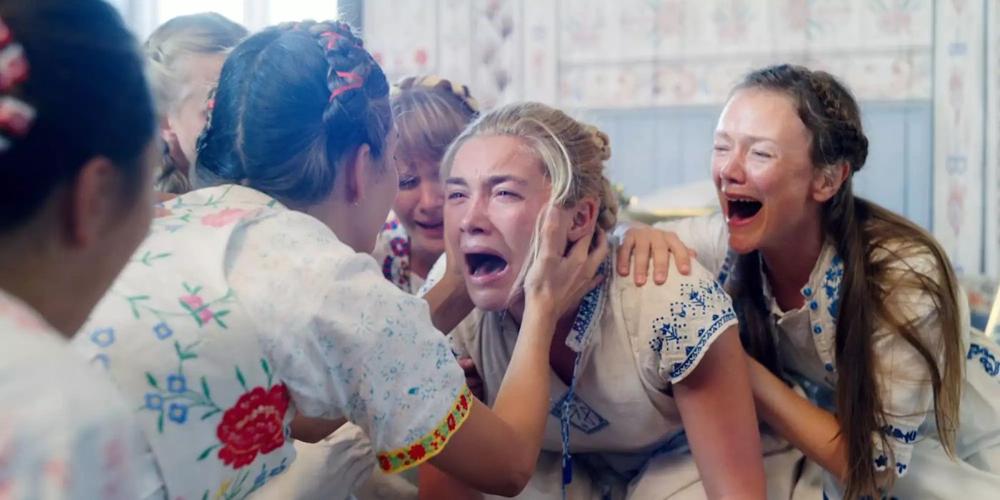 Dani crying while surrounded by other women in the film Midsommar